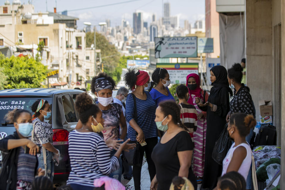 Dozens of Ethiopian domestic workers gather outside the Ethiopian consulate, some inquiring about flights home, others stranded after they were abandoned by employers who claimed they could no longer afford to pay their salaries, in Hazmieh, east of Beirut, Lebanon, Thursday, June 4, 2020. Some 180,000 domestic workers in Lebanon, most of them female from Ethiopia, are growing more desperate as a crippling economic and financial crisis sets in, coupled with coronavirus restrictions. (AP Photo/Hassan Ammar)