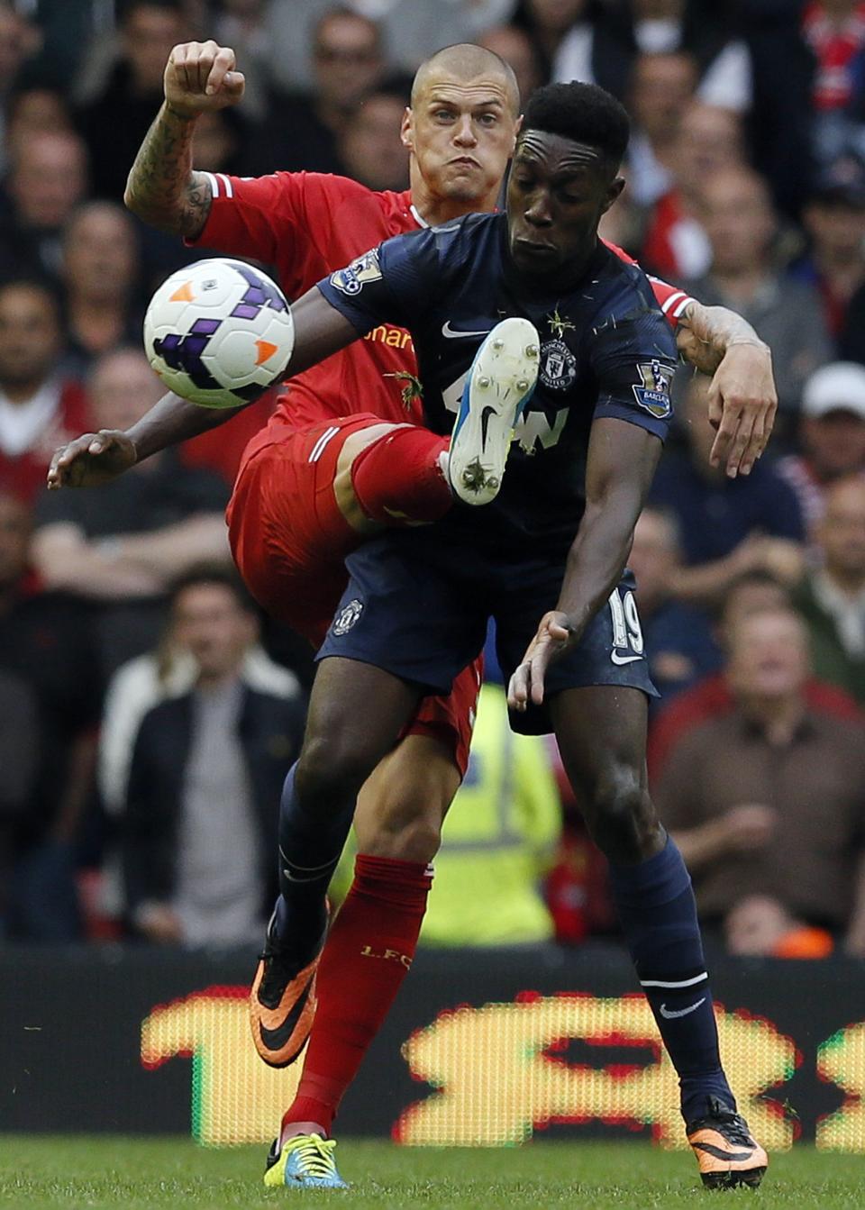 Liverpool's Skrtel challenges Manchester United's Welbeck during their English Premier League soccer match at Anfield