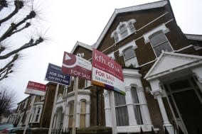 File photo dated 27/1/2014 of For Sale signs displayed outside houses in Finsbury Park, north London. Experts are warning that stronger curbs must be considered for the housing market amid fears that London is starting to show