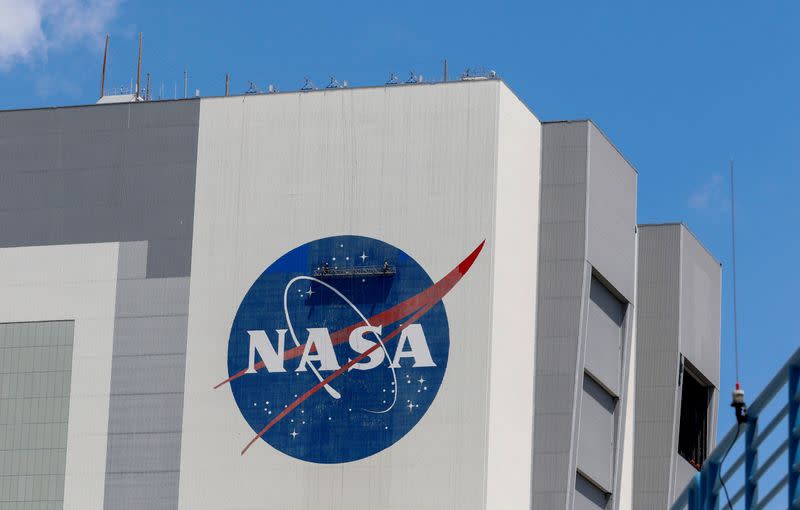 FILE PHOTO: Workers pressure wash the logo of NASA on the Vehicle Assembly Building, in Cape Canaveral