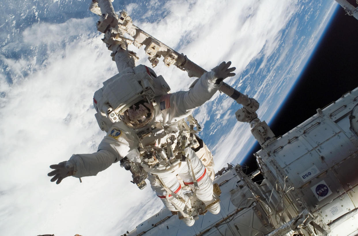 A Nasa astronaut carrying out a space walk. The agency has conducted research which shows the herpes virus can flare up in space. Stock image.