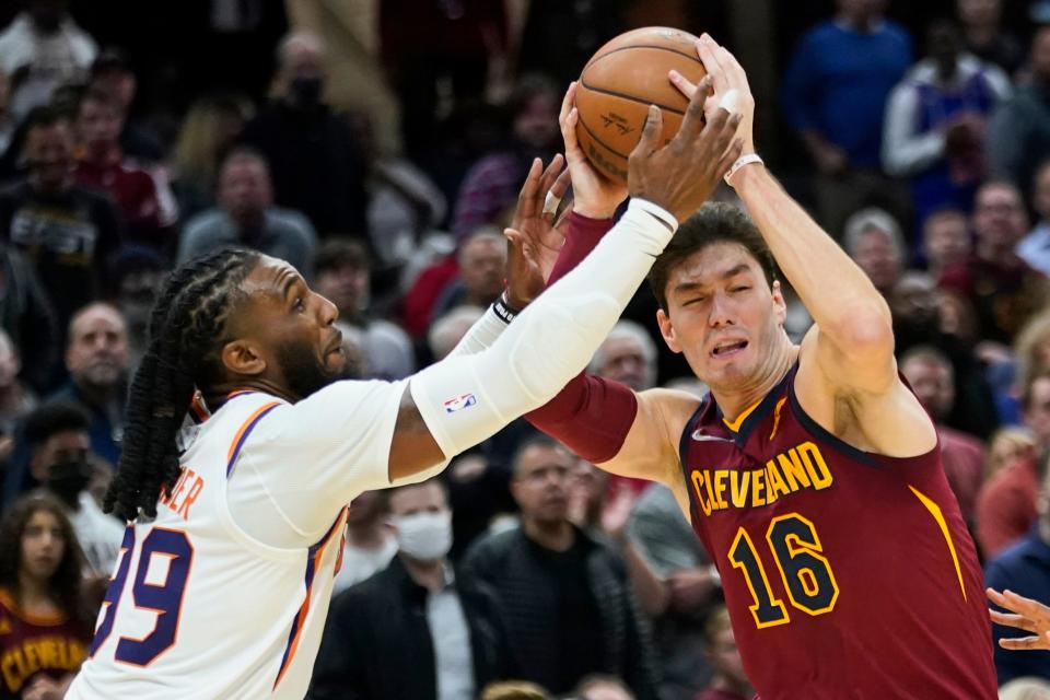 Cleveland Cavaliers' Cedi Osman (16) drives against Phoenix Suns' Jae Crowder (99) during the second half of an NBA basketball game, Wednesday, Nov. 24, 2021, in Cleveland. (AP Photo/Tony Dejak)