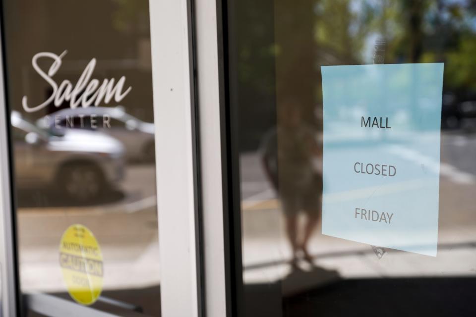 A sign on the door alerts people to Salem Center mall being closed after a stabbing occurred at the mall on May 12 in Salem.