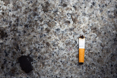 A cigarette butt litters the street in Lyon, France, June 14, 2018. The French government wants to end the bane of discarded cigarette butts and will impose new regulations unless tobacco companies come up with proposals to reduce their number. REUTERS/Emmanuel Foudrot