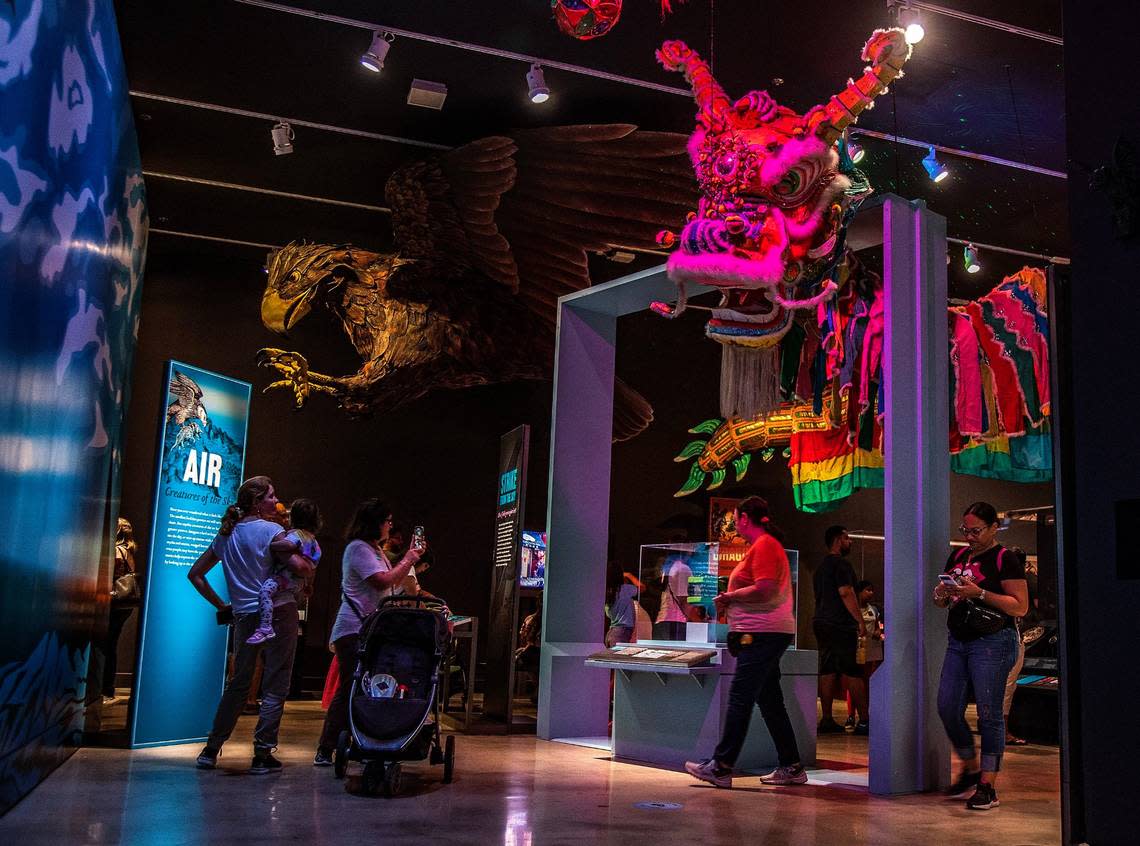 Visitors look at a giant model of a mythical Roc (left) and a a 120-foot-long Chinese parade dragon, used in New York City’s Chinatown to perform the traditional dragon dance at the Lunar New Year, part of the “Mythic Creatures: Dragons, Unicorns & Mermaids”, exhibition on display at the HistoryMiami Museum, The exhibition opening on July 8th, traces the natural and cultural roots of some of the world’s most enduring mythological creatures from Asia, Europe, the Americas, and beyond, and even how Miamians embrace their own mythic fantasies. Organized by theAmerican Museum of Natural History in New York, on Saturday, July 08, 2023. Pedro Portal/pportal@miamiherald.com