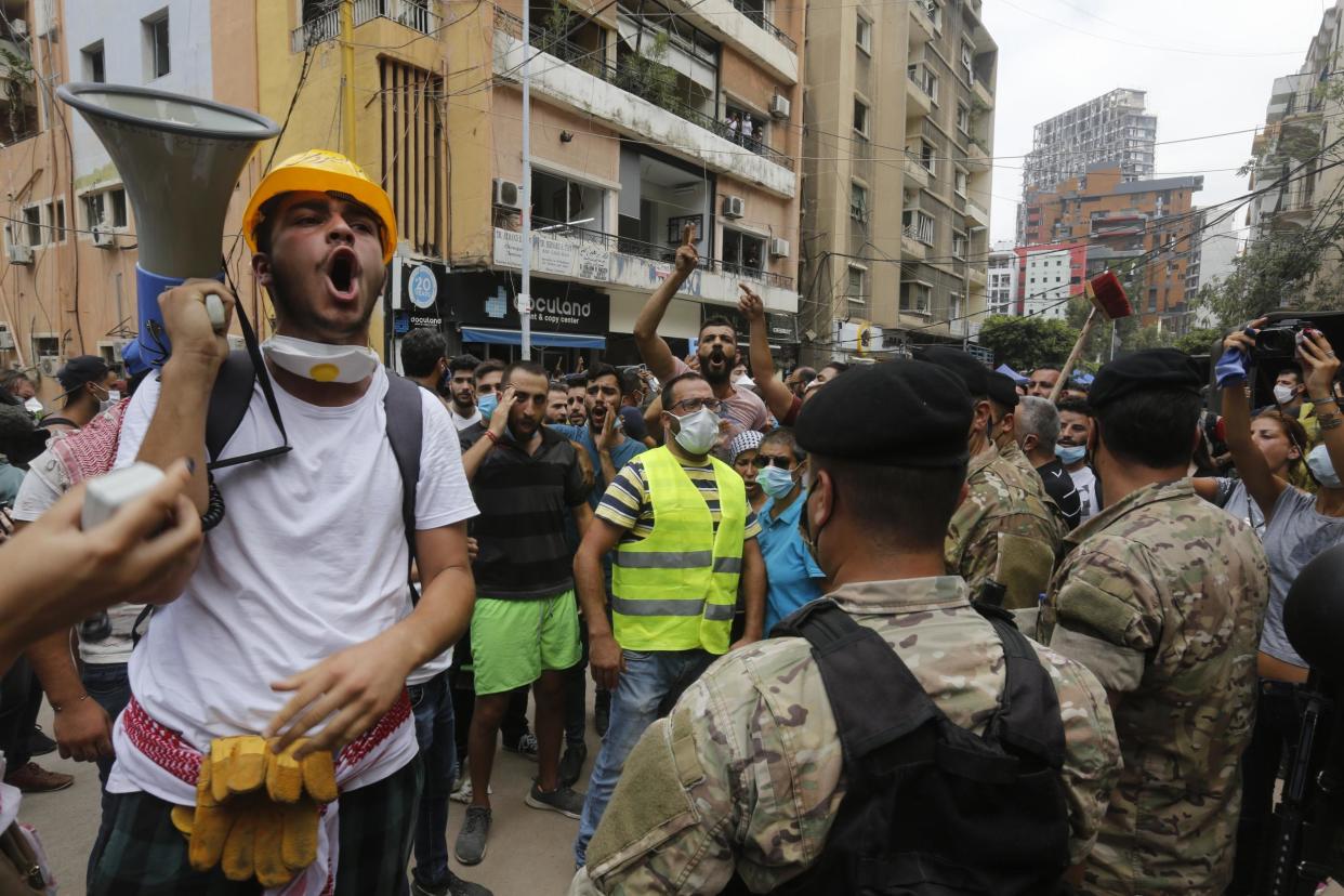 Members of the army hold back demonstrators, angry with the government negligence that allegedly contributed to Tuesday's explosion: Marwan Tahtah/Getty