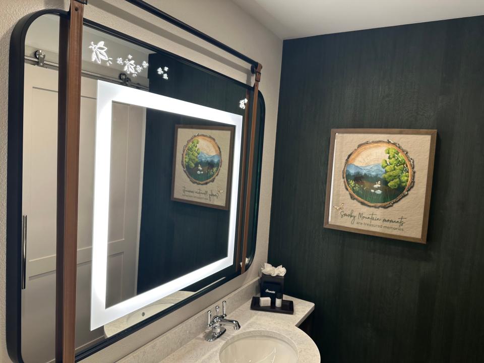Bathroom with bees and lights inside the mirror