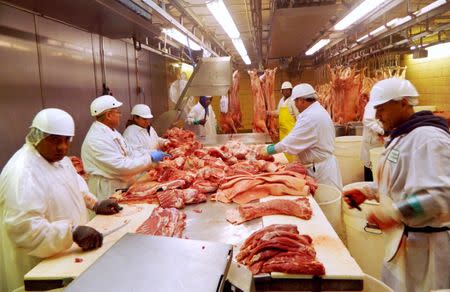 FILE PHOTO: Workers cut pork at Park Packing in Chicago, Illinois July 18, 2015. REUTERS/Karl Plume/File Photo