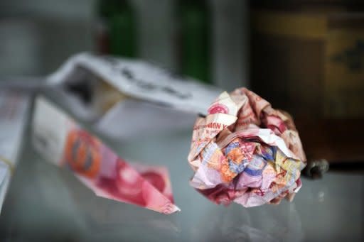 Yuan notes that were thrown over the wall of Chinese artist Ai Weiwei's home are displayed at his studio in Beijing on November 9, 2011. Ai, who denies that he evaded tax, has used money raised from supporters to allow him to lodge an appeal against the fine, but pledged to pay it back when the case is over