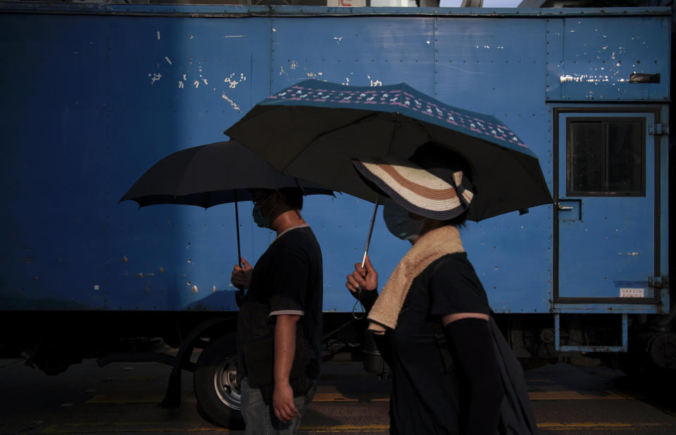 Protesters march with umbrella on Nathan road during a protest in Hong Kong, Saturday, Oct. 12, 2019. The protests that started in June over a now-shelved extradition bill have since snowballed into an anti-China campaign amid anger over what many view as Beijing's interference in Hong Kong's autonomy that was granted when the former British colony returned to Chinese rule in 1997. (AP Photo/Felipe Dana)