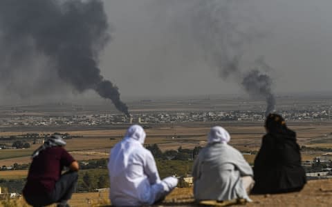 Turkish residents watched the fierce battle for the town from across the border - Credit: Ozan Kose/AFP