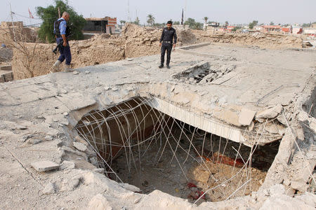 Iraq security forces gather at the site of a suspected air strike at a Shi'ite mosque during fighting in nearby Kirkuk last week in Daquq , Iraq, October 24, 2016. REUTERS/Ako Rasheed