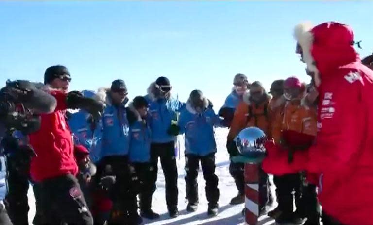 Britain's Prince Harry (L) and his fellow adventurers reach the South Pole in Antartica on December 13, 2013, as part of their Walking With The Wounded charity trek