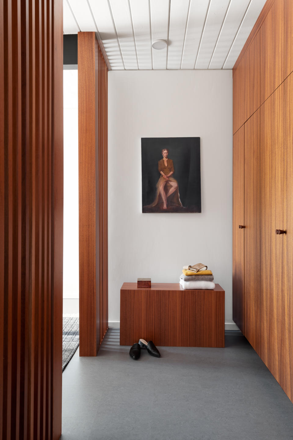 wood cupboards creating a dressing room area in a bedroom