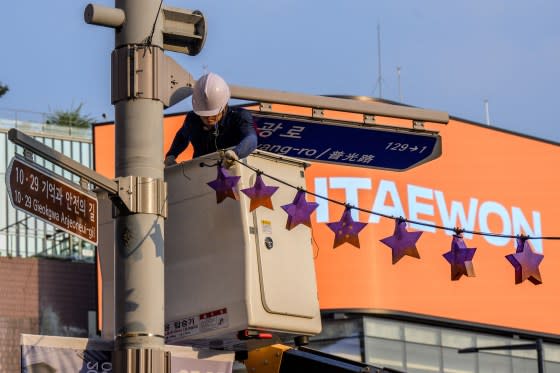 A worker displays star shaped lanterns in memory of victims of the Oct. 29 crowd crush that killed more than 150 people last Halloween, near the site of the tragedy in Itaewon, Seoul, on Oct. 25, 2023.<span class="copyright">Anthony Wallace—AFP/Getty Images</span>