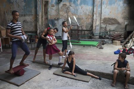 Children practise at a circus school during a training session in Havana, September 26, 2014. REUTERS/Alexandre Meneghini