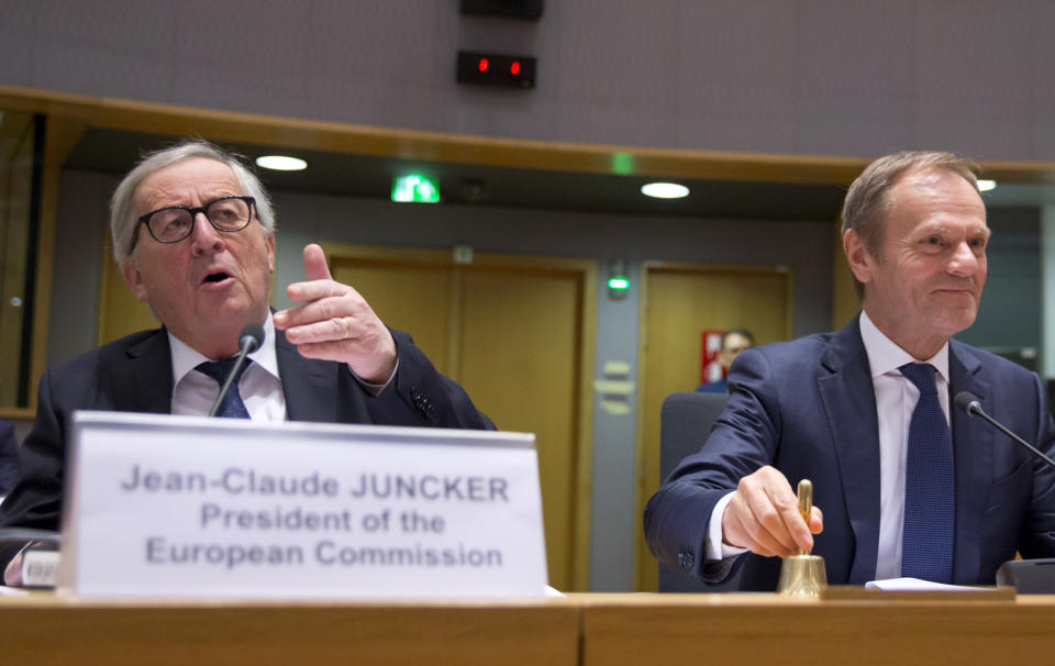 European Commission President Jean-Claude Juncker, left, speaks as European Council President Donald Tusk prepares to ring a bell to start a meeting at the Europa building in Brussels, Wednesday, March 20, 2019. European Union officials received a letter from British Prime Minister Theresa May requesting a Brexit extension and they hope to have more clarity about her intentions by Thursday. (AP Photo/Virginia Mayo)