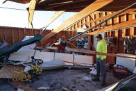 Patrick Crull tours the damage inside the detached garage next to his home Friday morning, Feb. 9, 2024, after a confirmed tornado went through the area just northwest of Evansville,Wis., the prior evening. The tornado was the first-ever reported in February in the state of Wisconsin, according to the National Weather Service. (Anthony Wahl//The Janesville Gazette via AP)