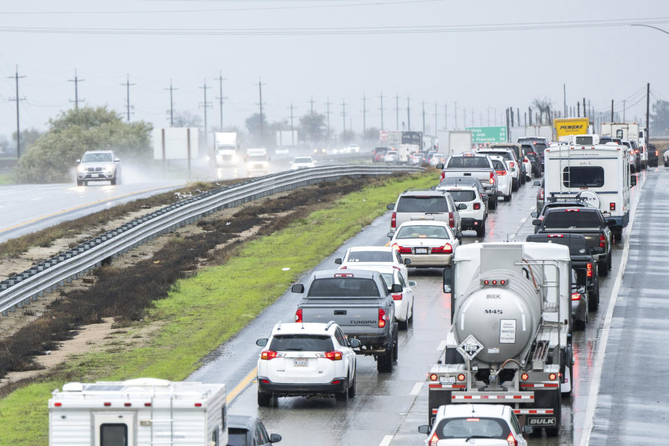 Cars are stopped in the northbound lanes of Highway 101 after flooding closed the highway near Chualar, Calif., Tuesday, Dec. 27, 2022. (AP Photo/Nic Coury)