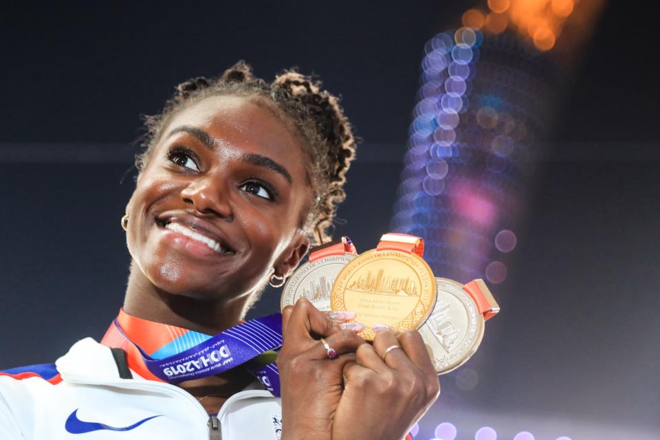 TOPSHOT - Britain's Dina Asher-Smith poses with her gold medal for the Women's 200m, silver medal for the Women's 100m and silver medal for the Women's 4x100m Relay during the medal ceremony at the 2019 IAAF Athletics World Championships at the Khalifa International stadium in Doha on October 6, 2019. (Photo by MUSTAFA ABUMUNES / AFP) (Photo by MUSTAFA ABUMUNES/AFP via Getty Images)