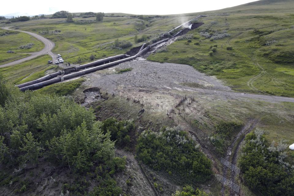 This photo released by the Bureau of Reclamation Missouri Basin Region, Montana Area Office, shows a breach in the St. Mary Canal siphon in Babb, Montana, Monday, June 17, 2024. The siphon is part of a system that carries water from a river on the Blackfeet Indian Reservation to another river that provides irrigation water to farmers and drinking water to 14,000 residents in northern Montana. No injuries or deaths have been reported since the century-old pipes broke open Monday. Officials do not know how long it will take to repair the damage. (Bureau of Reclamation Missouri Basin Region, Montana Area Office via AP)