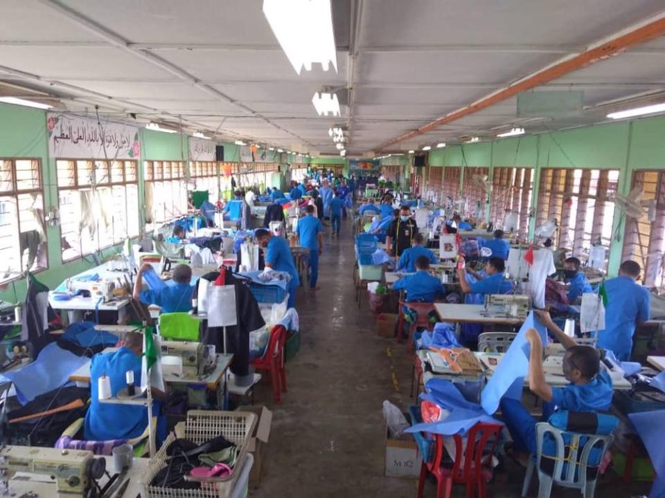 The inmates are tasked to measure, cut and sew the protective gear required by health workers treating Covid-19 patients. — Picture courtesy of Twitter/Malaysian Prisons Department