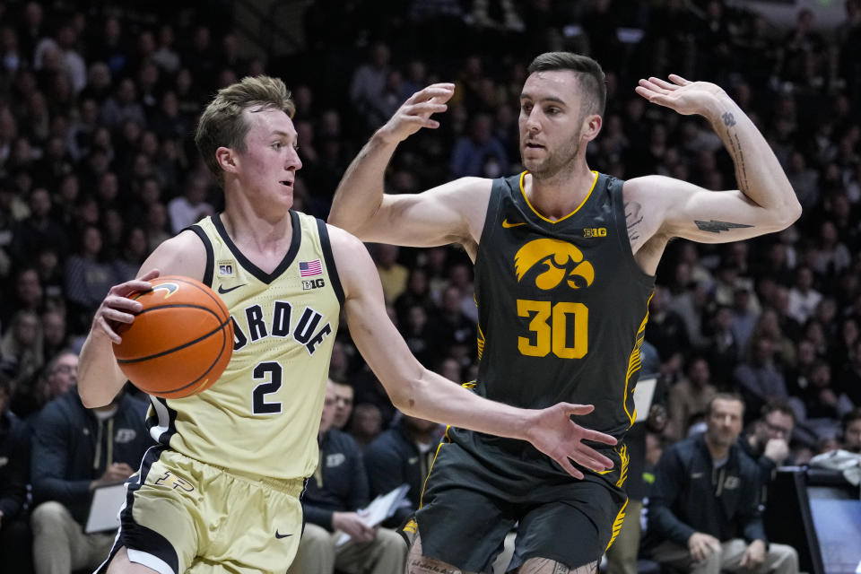 Purdue guard Fletcher Loyer (2) drives around Iowa guard Connor McCaffery (30) during the second half of an NCAA college basketball game in West Lafayette, Ind., Thursday, Feb. 9, 2023. Purdue defeated Iowa 87-73. (AP Photo/Michael Conroy)