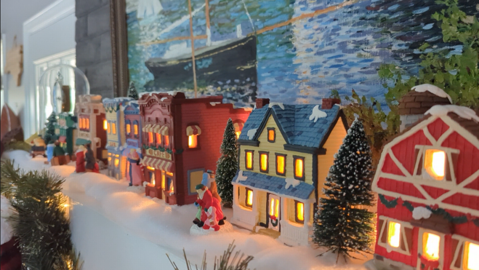 Dennis Mathias’ wife, Debra, handpainted the buildings that make up the couple’s cozy Christmas village.