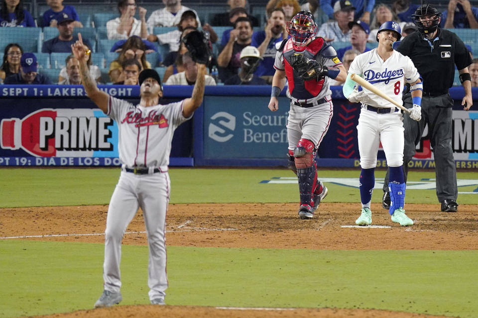 Atlanta Braves relief pitcher Raisel Iglesias, left, celebrates after striking out Los Angeles Dodgers' Kiké Hernández, second from right, to end the baseball game as catcher Sean Murphy, second from left, walks out to the mound and home plate umpire Dan Bellino watches Thursday, Aug. 31, 2023, in Los Angeles. (AP Photo/Mark J. Terrill)