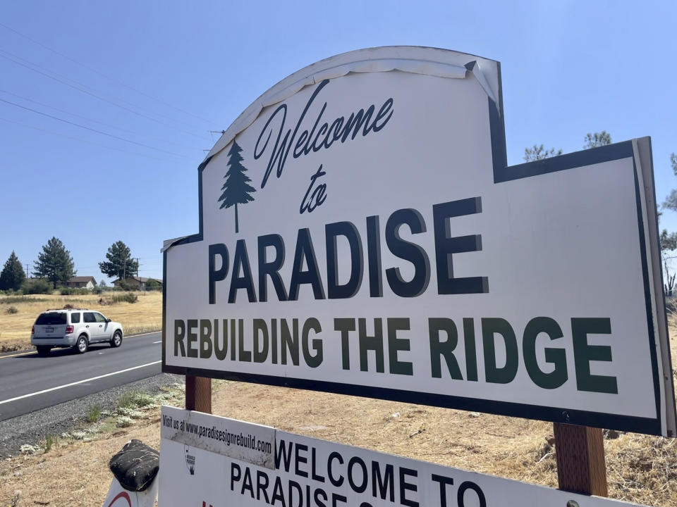 A sign welcomes motorists to Paradise, Calif., on Saturday, Aug. 5, 2023. Officials in Paradise, California, began testing a new wildfire siren system this summer as the five-year anniversary of the deadly and devastating Camp Fire approaches. Reliable warning systems are becoming more critical during wildfires, especially as power lines and cell towers fail, knocking out communications critical to keeping people informed. (AP Photo/Haven Daley)