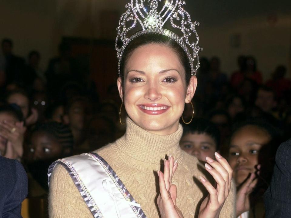 CIRCA 2000: Miss Universe Denise Quinones is in the spotlight on a visit to Public School 83 in Harlem