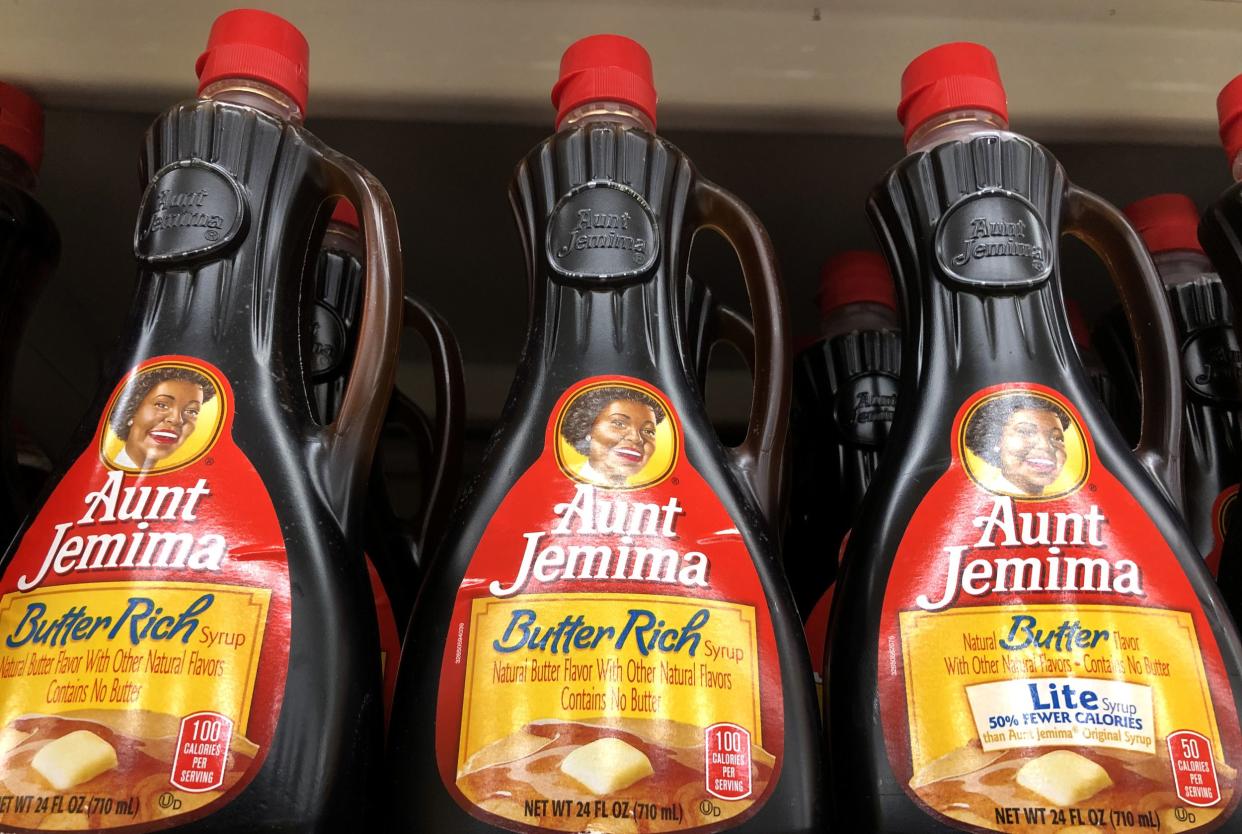 Bottles of Aunt Jemima pancake syrup displayed on a shelf at a Safeway store, three bottles in the foreground