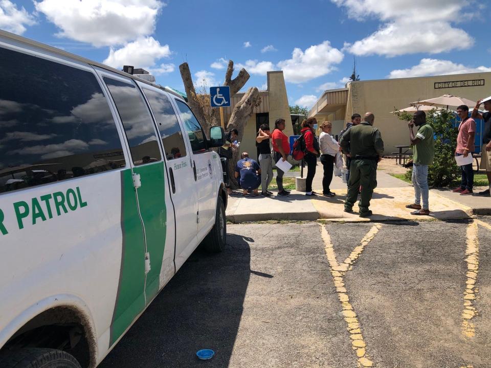 U.S. Border Patrol agents drop off asylum-seekers last fall at the Val Verde Border Humanitarian Coalition migrant shelter in Del Rio. Many of the migrants will later take state-funded bus rides to Washington, New York or Chicago.