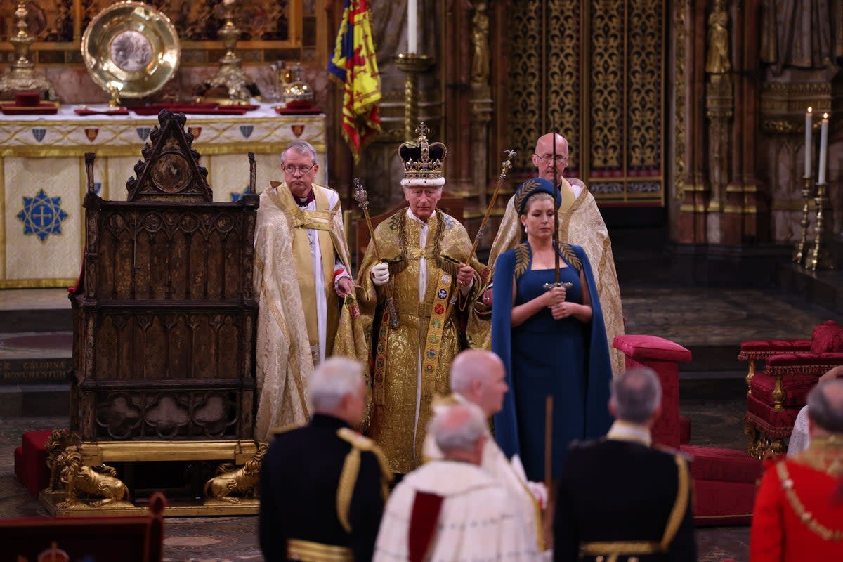 The King with Lord President of the Council, Penny Mordaunt, carrying the Sword of State, during his coronation at Westminster Abbey (Richard Pohle/The Times/PA) (PA Wire)