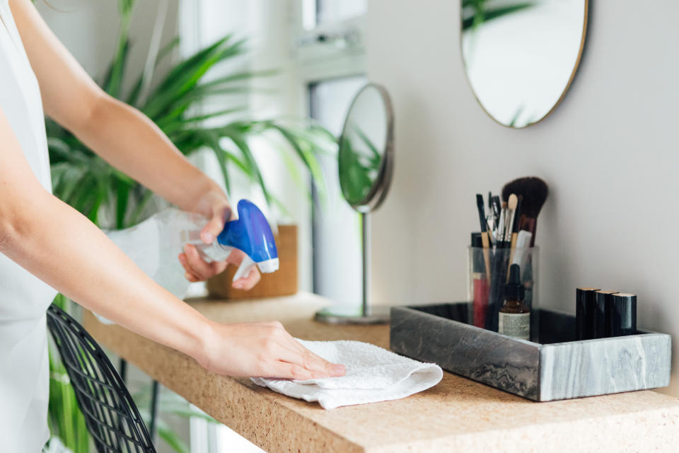 woman cleaning bedroom