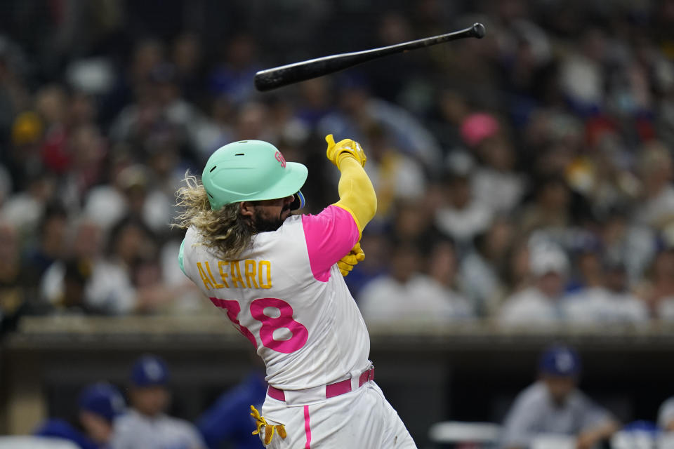 San Diego Padres' Jorge Alfaro loses his bat during the sixth inning of the team's baseball game against the Los Angeles Dodgers, Friday, Sept. 9, 2022, in San Diego. (AP Photo/Gregory Bull)