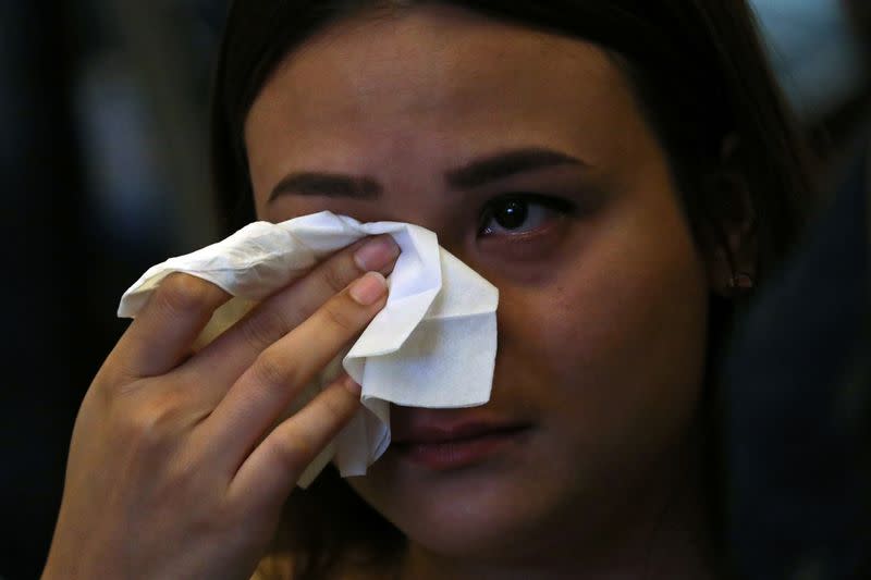 Victim's family member wipes her tears during the sixth annual remembrance event for the missing Malaysia Airlines flight MH370 in Putrajaya