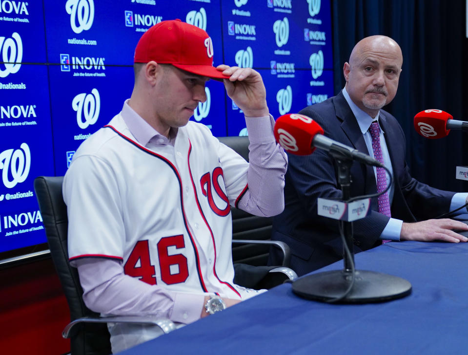 Washington Nationals President of Baseball Operations and General Manager Mike Rizzo, right, announces the signing of pitcher Patrick Corbin, left, during a news conference at Nationals Park in Washington, Friday, Dec. 7, 2018. (AP Photo/Pablo Martinez Monsivais)