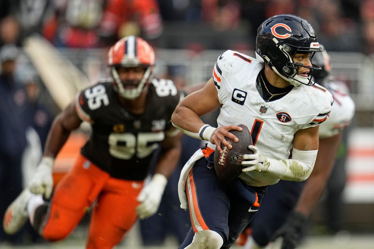Chicago Bears quarterback Justin Fields (1) runs the ball in the second half of an NFL football game against the Cleveland Browns in Cleveland, Sunday, Dec. 17, 2023. (AP Photo/Sue Ogrocki)