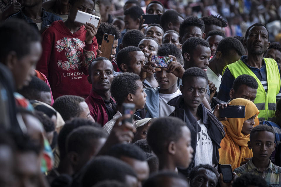 Supporters in the stands take pictures with their smartphones at the final campaign rally of Ethiopia's Prime Minister Abiy Ahmed, in the town of Jimma in the southwestern Oromia Region of Ethiopia Wednesday, June 16, 2021. The country is due to vote in a general election on Monday, June, 21, 2021. (AP Photo/Mulugeta Ayene)