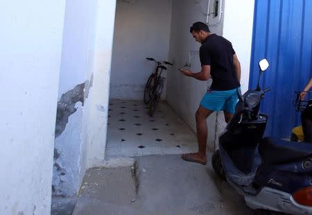 Jabeur Lahouaiej Bouhlel, the brother of Mohamed Lahouaiej Bouhlel, the man who drove a heavy truck into crowds in the French city of Nice killing at least 84 people on Friday, holds his phone near his house in Msaken, Tunisia, July 15, 2016. REUTERS/Zoubeir Souissi