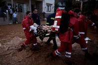 <p>Hellenic Red Cross volunteers and firemen evacuate an elderly man following heavy rainfall in the town of Mandra, Greece, Nov. 16, 2017. (Photo: Alkis Konstantinidis/Reuters) </p>