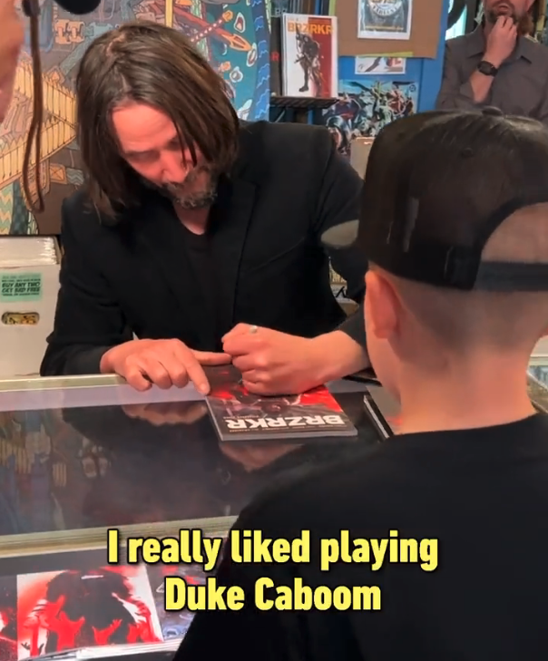 keanu giving an autograph