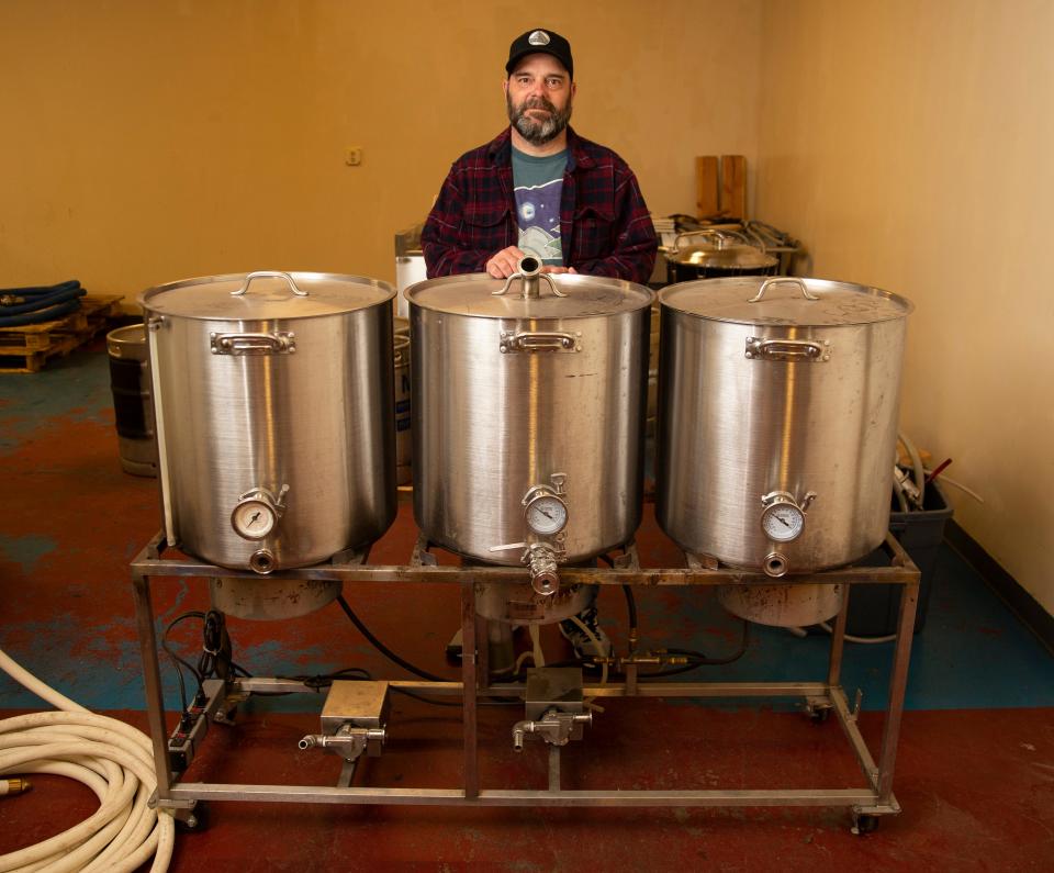 Cam Wells with the smaller brewing system he and Chris Archer used when they began making beer.