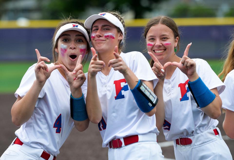 Fairport’s Morgan Kennedy, left, Rachel McCoy and Courtney Heininger celebrate after the Section V Class AA Championship at Greece Odyssey High School, Saturday, May 28, 2022. No. 1 seed Fairport won the AA title with a 2-1 win over No. 2 seed Victor.