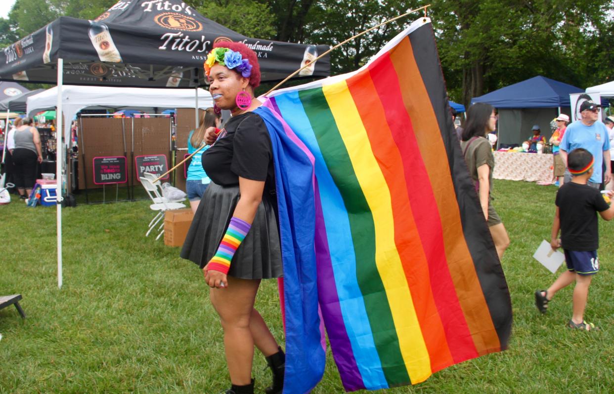 Madeline Porter of Wilmington displays a rainbow flag during Delaware Pride Festival in Dover on June 1, 2019