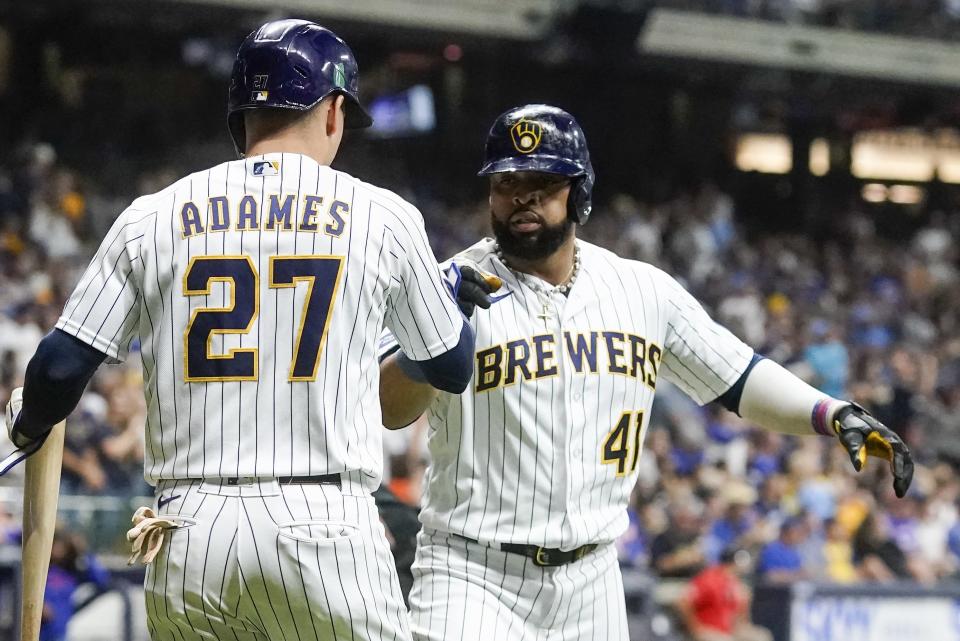 Milwaukee Brewers' Carlos Santana is congratulated by Willy Adames after hitting a home run during the second inning of a baseball game against the Chicago Cubs Saturday, Sept. 30, 2023, in Milwaukee. (AP Photo/Morry Gash)