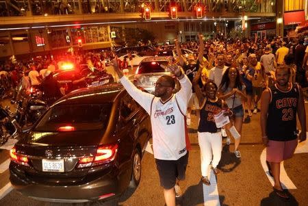 Cleveland Cavaliers fans celebrate in the streets outside of Quicken Loans Arena in Cleveland, Ohio after the Cavaliers defeated the Golden State Warriors in the NBA Championship Game played in Oakland, California June 19, 2016. REUTERS/Aaron Josefczyk