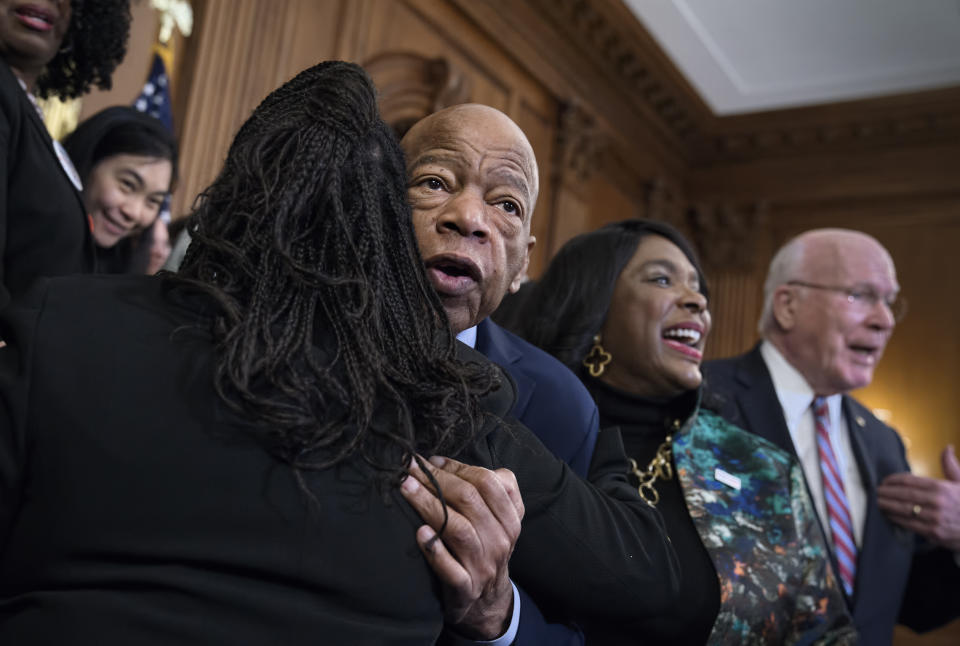 Civil rights leader Rep. John Lewis, D-Ga., is hugged as House Democrats gathered before passing the Voting Rights Advancement Act to eliminate potential state and local voter suppression laws, at the Capitol in Washington, Friday, Dec. 6, 2019. At right is Rep. Terri Sewell, D-Ala., who introduced the bill and who represents Selma, Ala., a city that was at the forefront of the 1960s civil rights movement. They are joined at far right by Sen. Patrick Leahy, D-Vt. (AP Photo/J. Scott Applewhite)