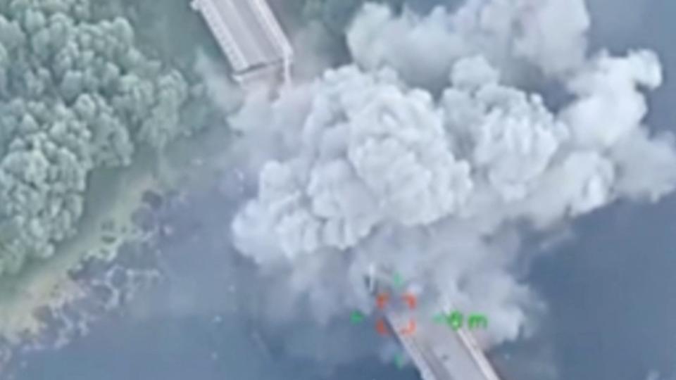 Smoke rises from a bridge over the Seim River in Glushkovsky district after a Ukrainian attack. The bridge is broken into two parts.